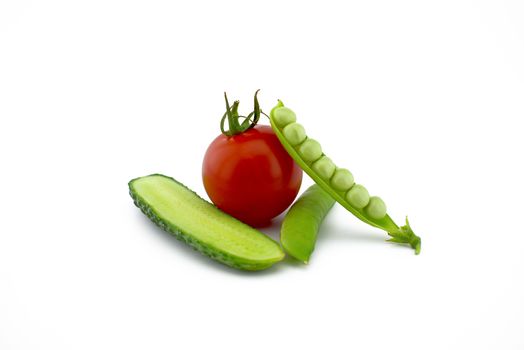 Red ripe tomato, peas in a pod and cucumber isolated on white background
