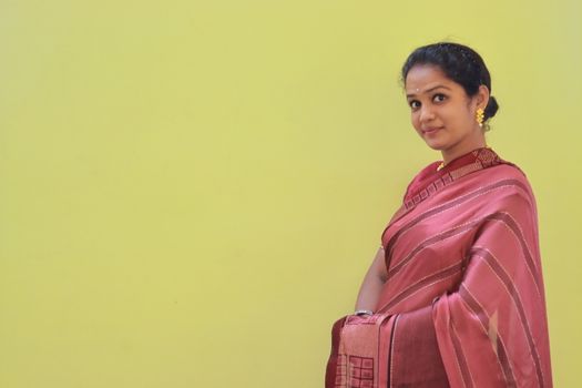 A model woman depicting a new design of saree with copy space background