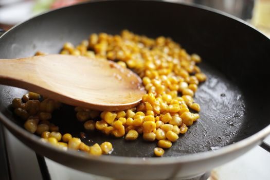 Diet. Organic Grilled Corn in a frying pan. Organic farm vegetables. Gray background Top view. Wooden spoon. Vegetarian food. Environmentally friendly products