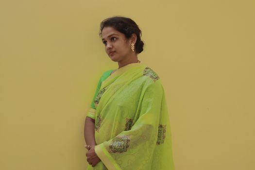 gorgeous model women in new green saree design on orange background