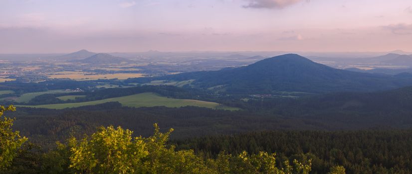 Lusatian Mountains (luzicke hory) wide panorama, panoramic view from Hochwald (Hvozd) mountain on czech german borders with blue green hills forest and pink cloudy sunset sky background