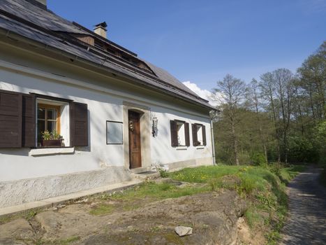 old sand stone cottage and footpath on the countryside in early spring