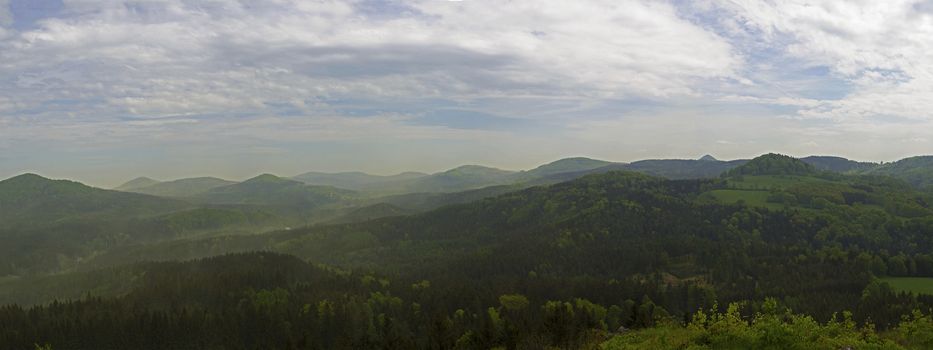 luzicke hory mountains wide panorama, skyline view from hill stredni vrch, green forest and blue sky, white clouds background