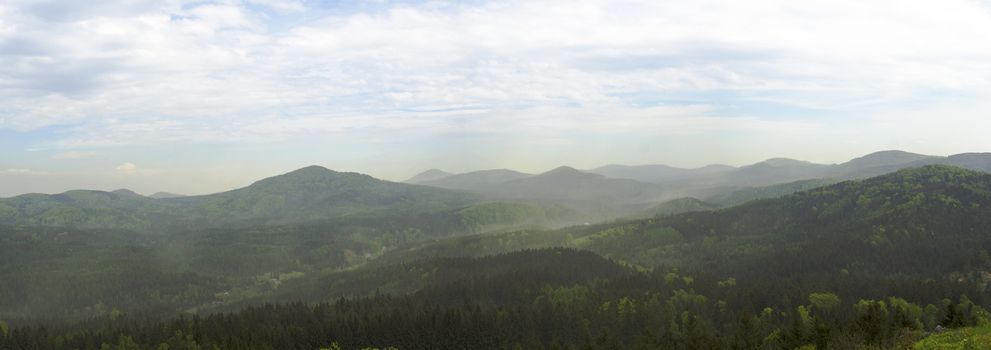 luzicke hory mountains wide panorama, skyline view from hill stredni vrch, green forest and blue sky, white clouds background