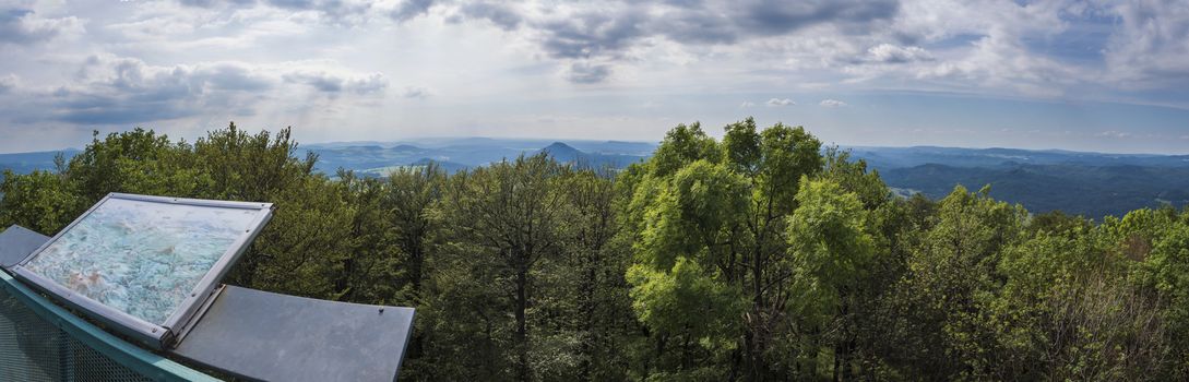 Panoramic view from looking tower on hill studenec with beech forest blue hills and sky. Czech Republic Lusitian mountains Luzicke hory
