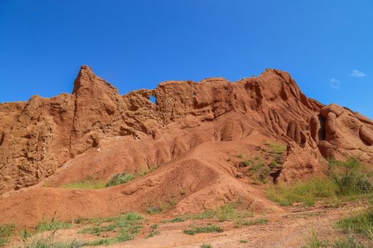 Red sandstone rock formations Seven bulls and Broken heart, Jeti Oguz canyon in Kyrgyzstan, Issyk-Kul region, Central Asia