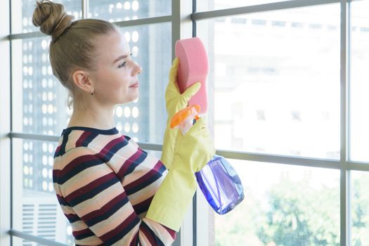 Beautiful young Caucasian women In casual wear, wearing yellow rubber gloves Prepare for laundry, clothes, and house cleaning. Attractive clean modern housekeeper, smiling and happy for the chore.