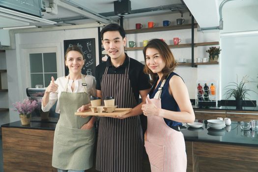 portrait Working together, coffee shop owner Asian mature women With barista, young Asian man, and Waitress young woman Caucasian people Cafe background of drink service Relaxing concept