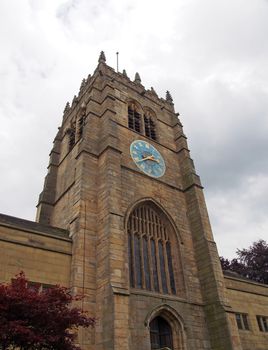 the tower of medieval bradford cathedral in west yorkshire with clock and windows