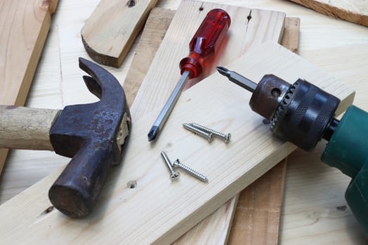 screwdriver nut and hammer on wood too for construction craft 