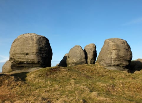 view of the bridestones a large group of gritstone rock formations in west yorkshire landscape near todmorden