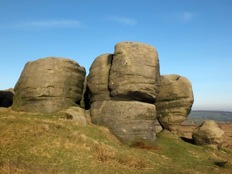 view of the bridestones a large group of gritstone rock formations in west yorkshire landscape near todmorden