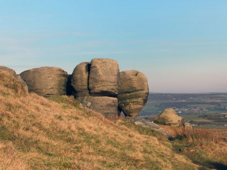 the bridestones a large group of gritstone rock formations in west yorkshire landscape near todmorden against pennine countryside