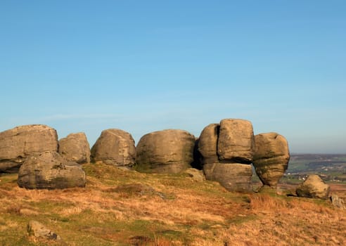 view of the top of the bridestones a large group of gritstone rock formations in west yorkshire landscape near todmorden