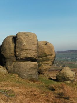 the large group of boulders at the bridestones a large group of gritstone rock formations in west yorkshire landscape near todmorden against pennine countryside