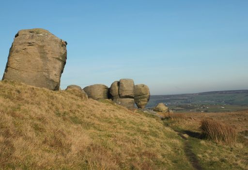 the bridestones a large group of gritstone rock formations in west yorkshire landscape near todmorden against pennine countryside