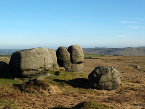 rock formations in bridestones moor in west yorkshire with a panoramic view over pennine countryside