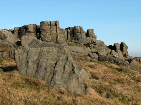 large rugged gritstone outcrop at the bridestones a large rock formation in west yorkshire near todmordenwith blue sky and surrounding countryside