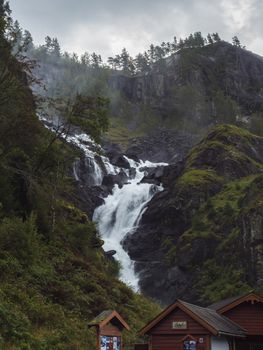 Powerful twin waterfall Latefoss or Latefossen and six arched bridge along Route 13, Odda Hordaland County in Norway. Early autumn, moody sky
