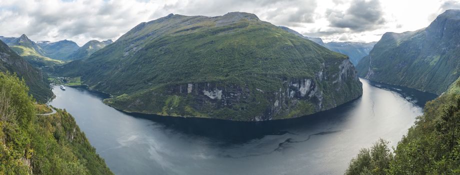 Panorama of Geirangerfjord in Sunnmore region, Norway, one of the most beautiful fjords in the world, included on the UNESCO World Heritage. View from Ornesvingen eagle road viewpoint, early autumn, cloudy day