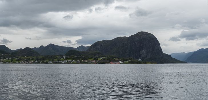Beautiful Wide panoramic view on Norwegian fjord. View across Storfjorden, towards village Eidsdal. Summer, blue sky. Norway.