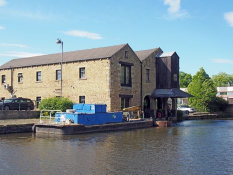 a view of buildings around the brighouse basin with moored boat on the calder and hebble navigation canal in calderdale west yorkshire