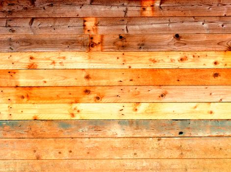 colorful old rustic wooden plank wall or floor with rich brown colored boards made of reused timber