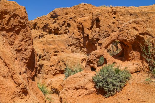 Red sandstone rock formations Seven bulls and Broken heart, Jeti Oguz canyon in Kyrgyzstan, Issyk-Kul region, Central Asia