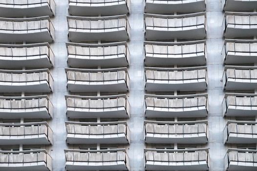 gray concrete facade with balconies for background