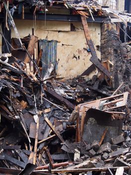 black burned timbers debris and walls in a collapsed house destroyed by fire
