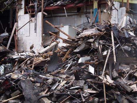 black burned timbers and walls in a collapsed house destroyed by fire