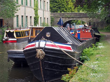 old barges and houseboats moored on the rochdale canal in hebden bridge in west yorkshire