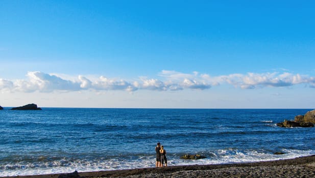 A man and a woman on the beach near the sea