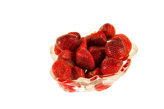 Vase with red berries and ripe strawberry

