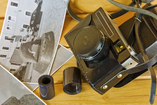 Cameras, film, photo album and on the surface of wood

