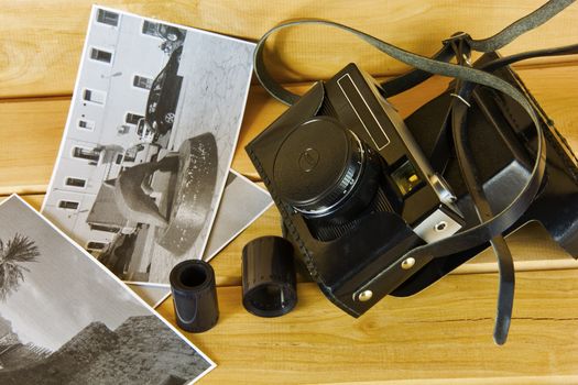 Cameras, film, photo album and on the surface of wood

