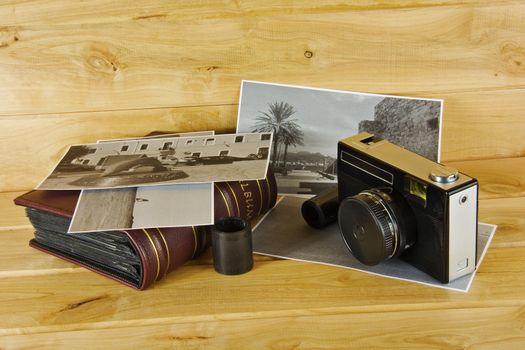 Cameras, film, photo album and on the surface of wood

