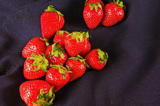 Ripe strawberries on a black background

