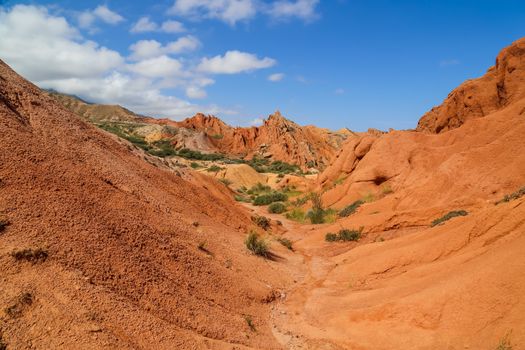 Red sandstone rock formations Seven bulls and Broken heart, Jeti Oguz canyon in Kyrgyzstan, Issyk-Kul region, Central Asia