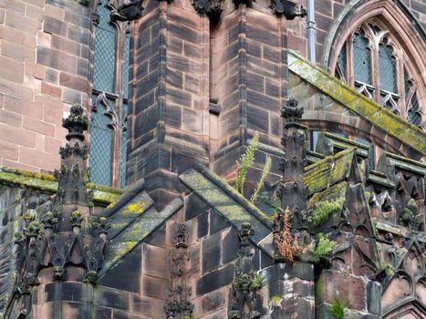 close up view of ornate moss covered medieval stonework on the historic chester cathedral
