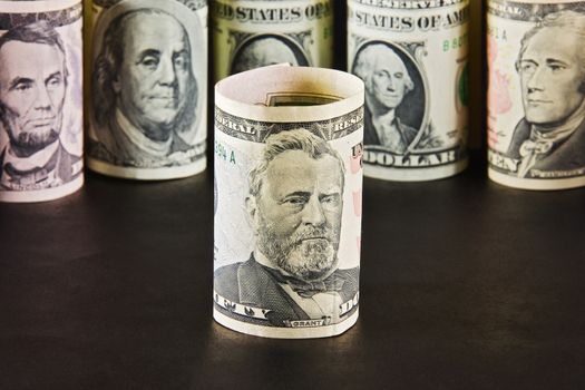President with ten dollar bills on a background of presidents from other denominations

