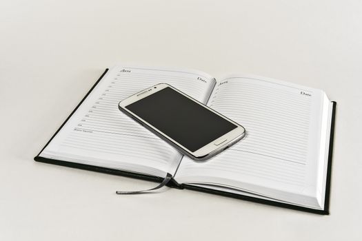 Diary and smartphone on a white background
