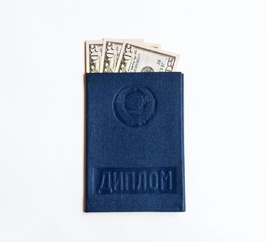 The US currency is enclosed in a paper on graduation (diploma) on a white background
