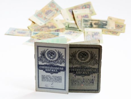 Savings books of the Soviet Union, are standing upright. In the background is seen the Soviet rubles without harshness