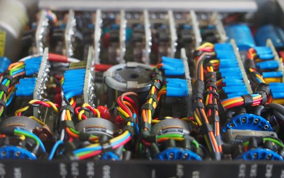 selective focus image of complex colored wiring and connectors joining circuit boards with electrical components