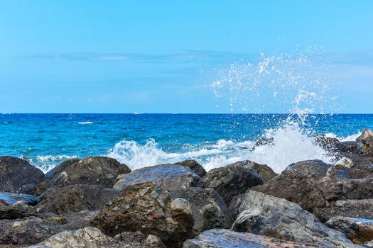 Splashes of water breaking on coastal rocks