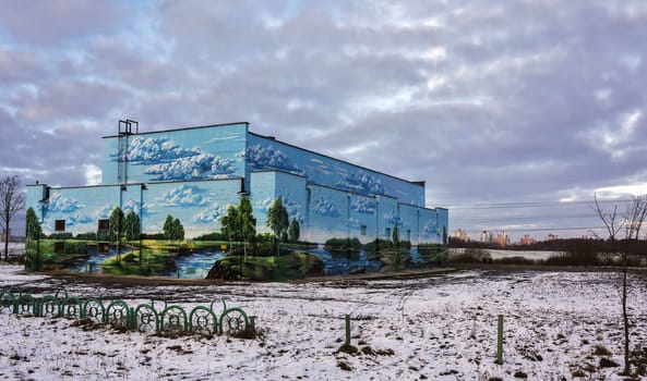 On the walls of the building drawn summer landscape