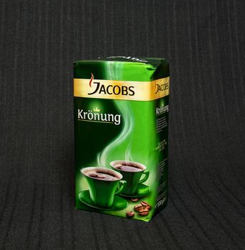 Packing Jacobs coffee on a black background
