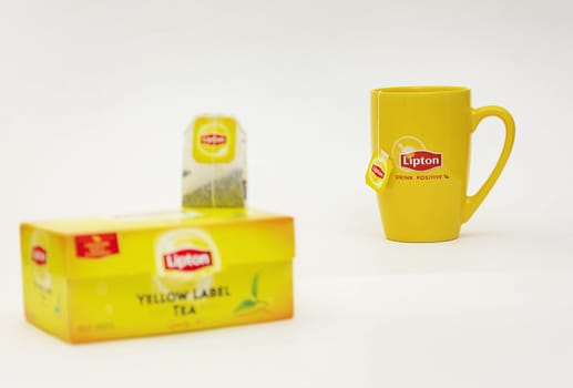 Yellow mug and tea bag packing with Lipton