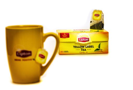 Yellow mug and tea bag packing with Lipton